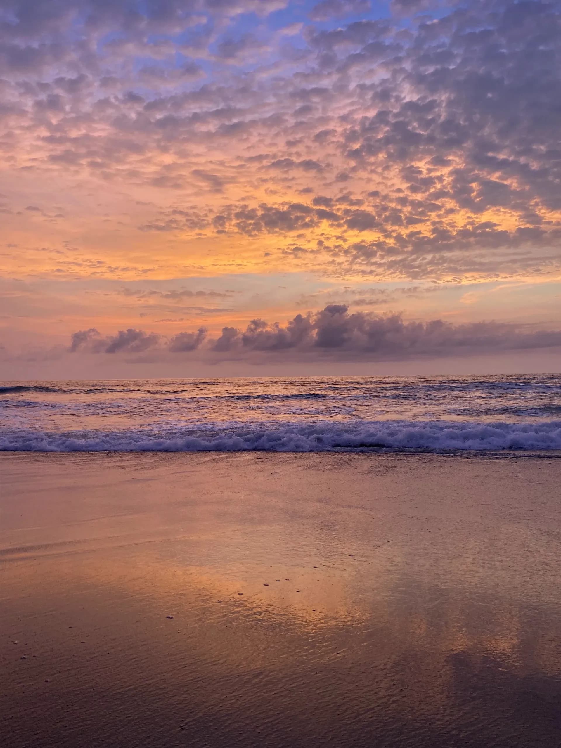 Gentle waves crashing on the pristine beach of Litibu, Nayarit, during a golden sunset.