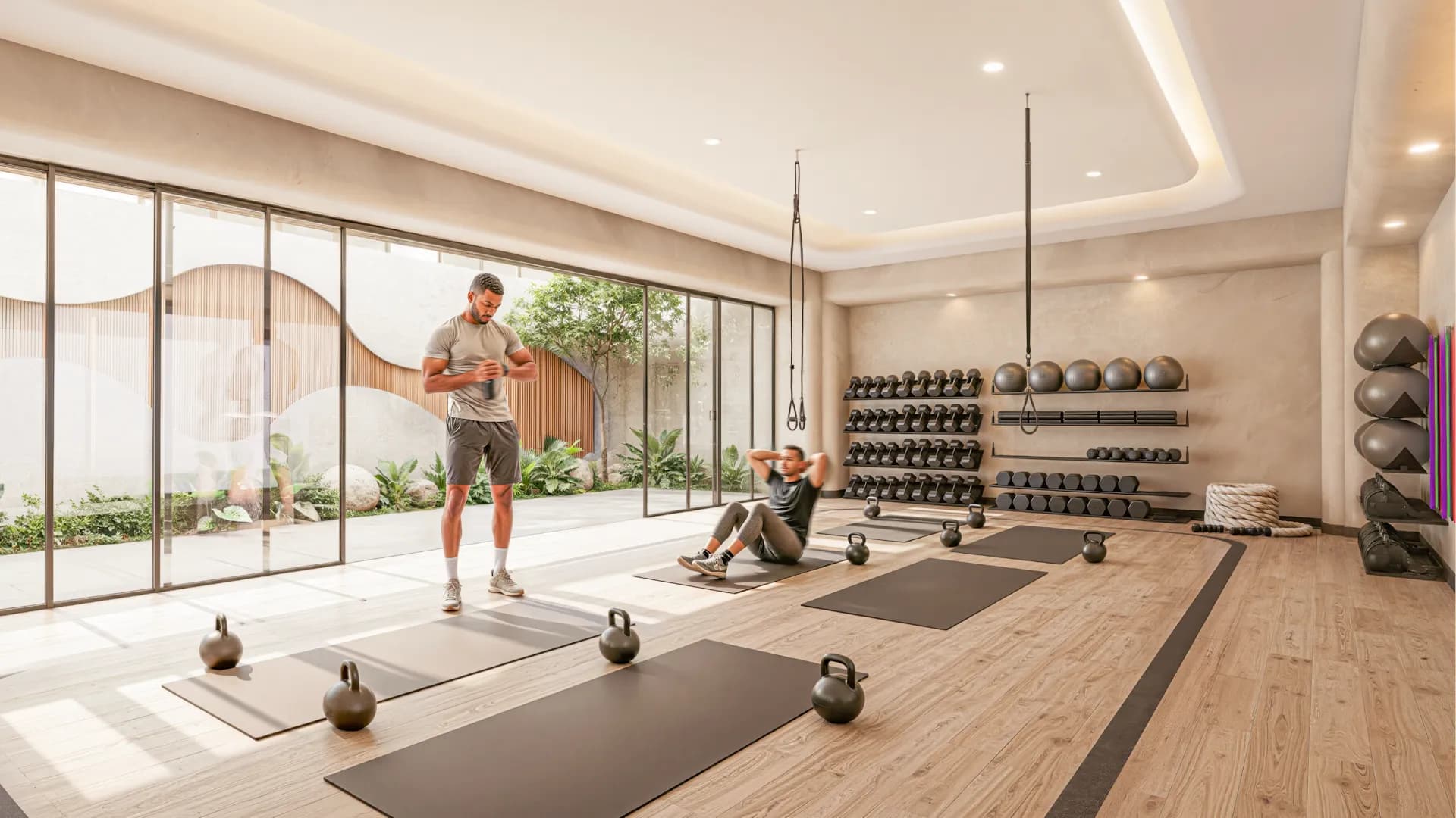 Modern fitness studio at Amapas 314 equipped with free weights, kettlebells, workout mats, suspension trainers, and floor-to-ceiling glass doors opening to a lush garden patio