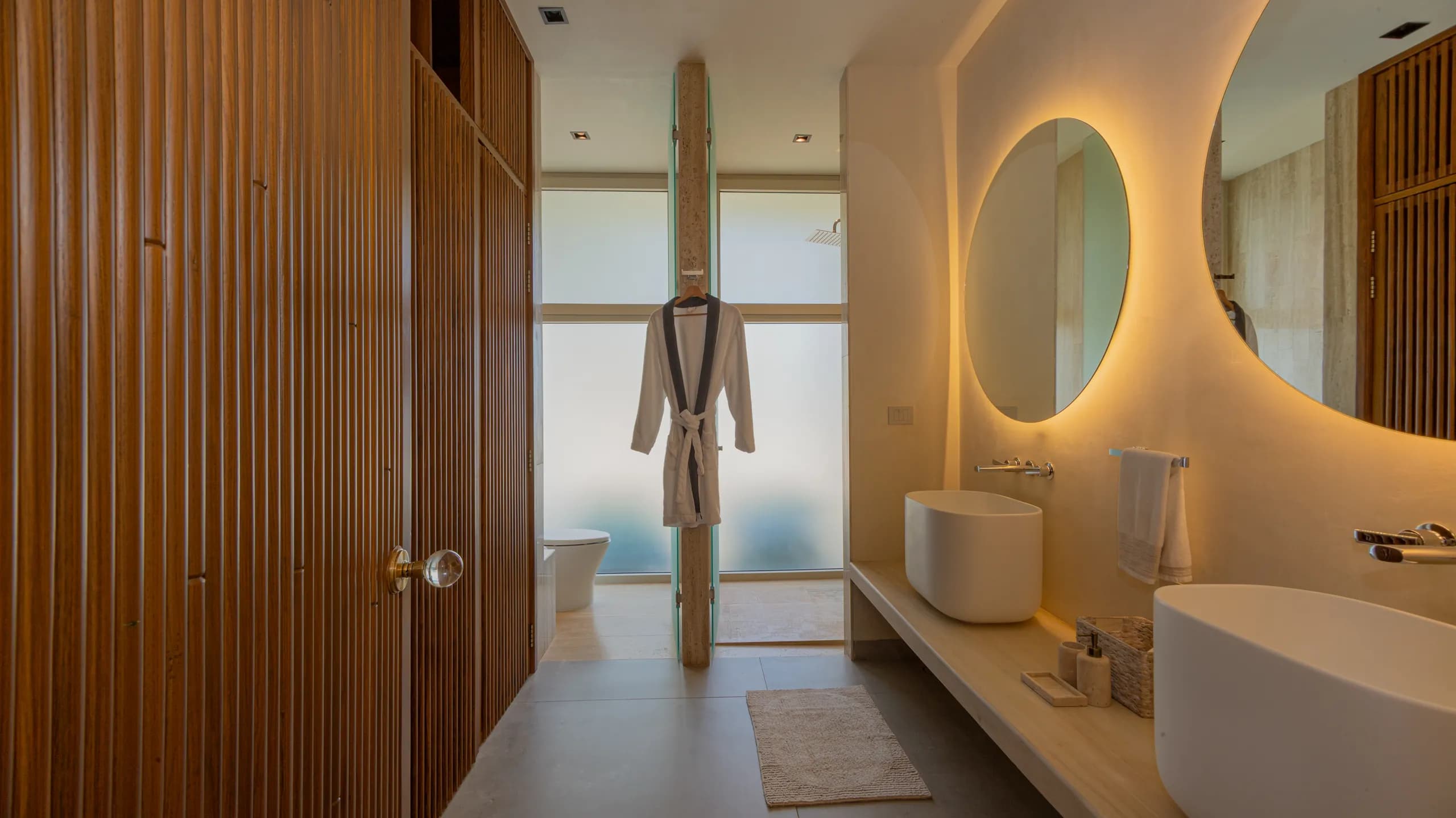 Spa-inspired bathroom featuring natural textures, warm lighting, and contemporary finishes throughout.
