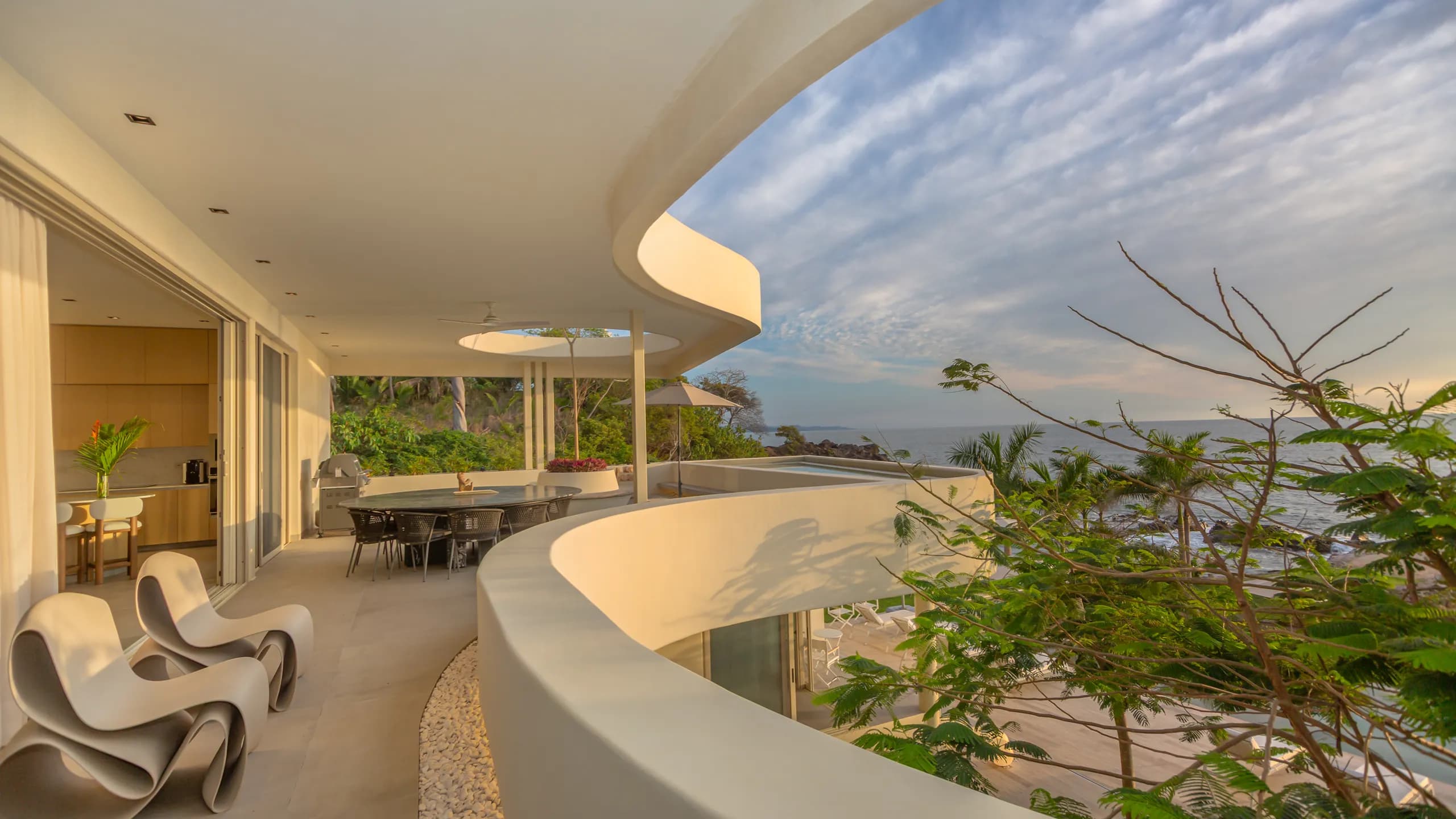 Curved architectural lines and open terraces frame panoramic views while enhancing airflow and natural light throughout the residence.