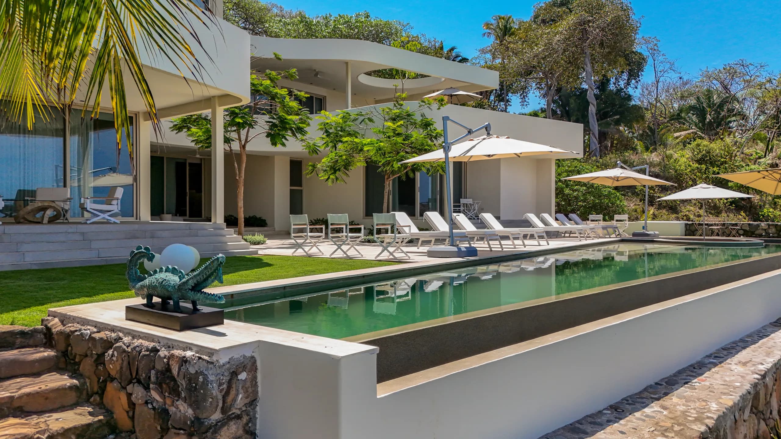 Minimalist exterior design combined with resort-inspired amenities creates a residence focused on privacy and coastal sophistication.